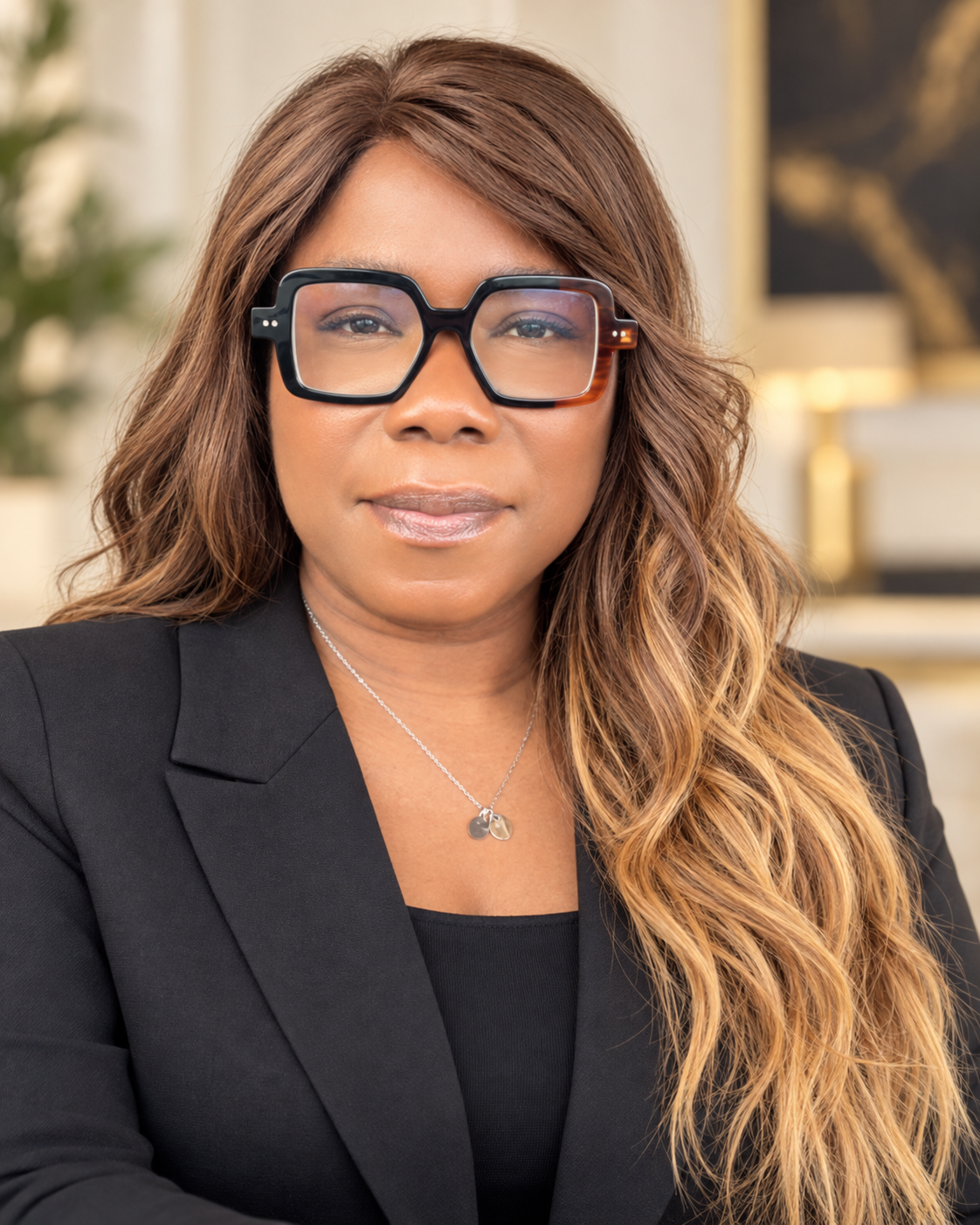 Sandra Atoge, founder of iHobbs Hair Loss Clinic and iHobbs Academy, seated at her desk.